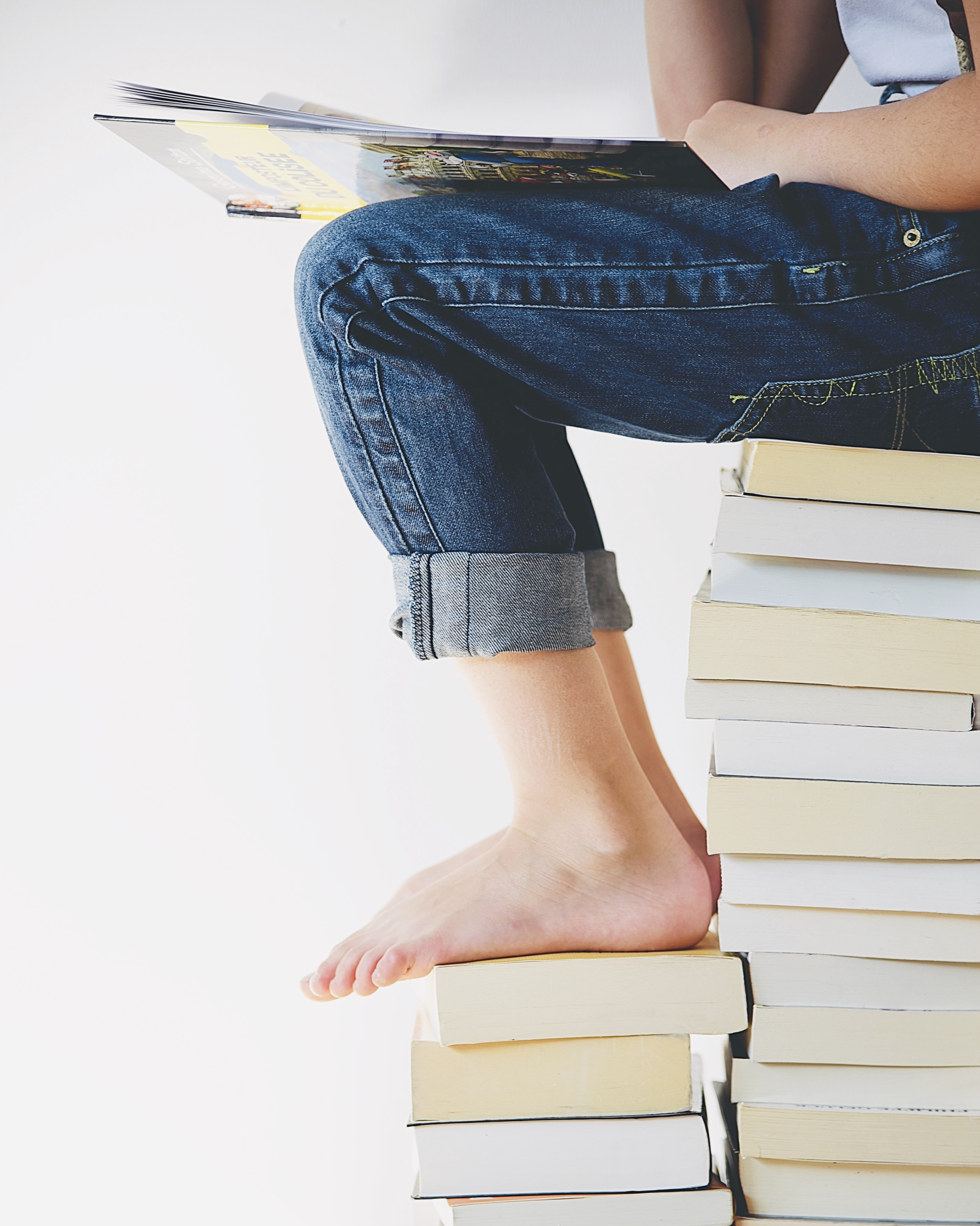 Sitting on a pile of books and reading